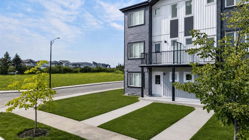 Corner home with balcony overlooking open green space